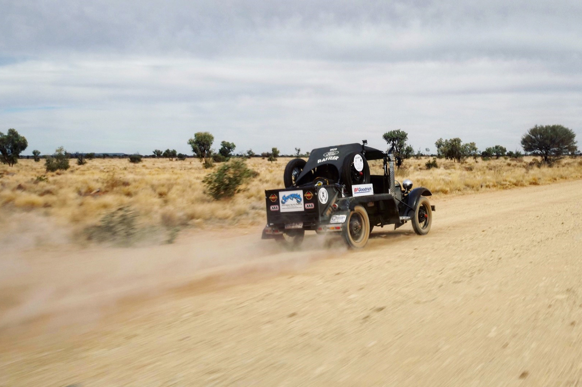 Vehicle speeding along dirt road in Australia