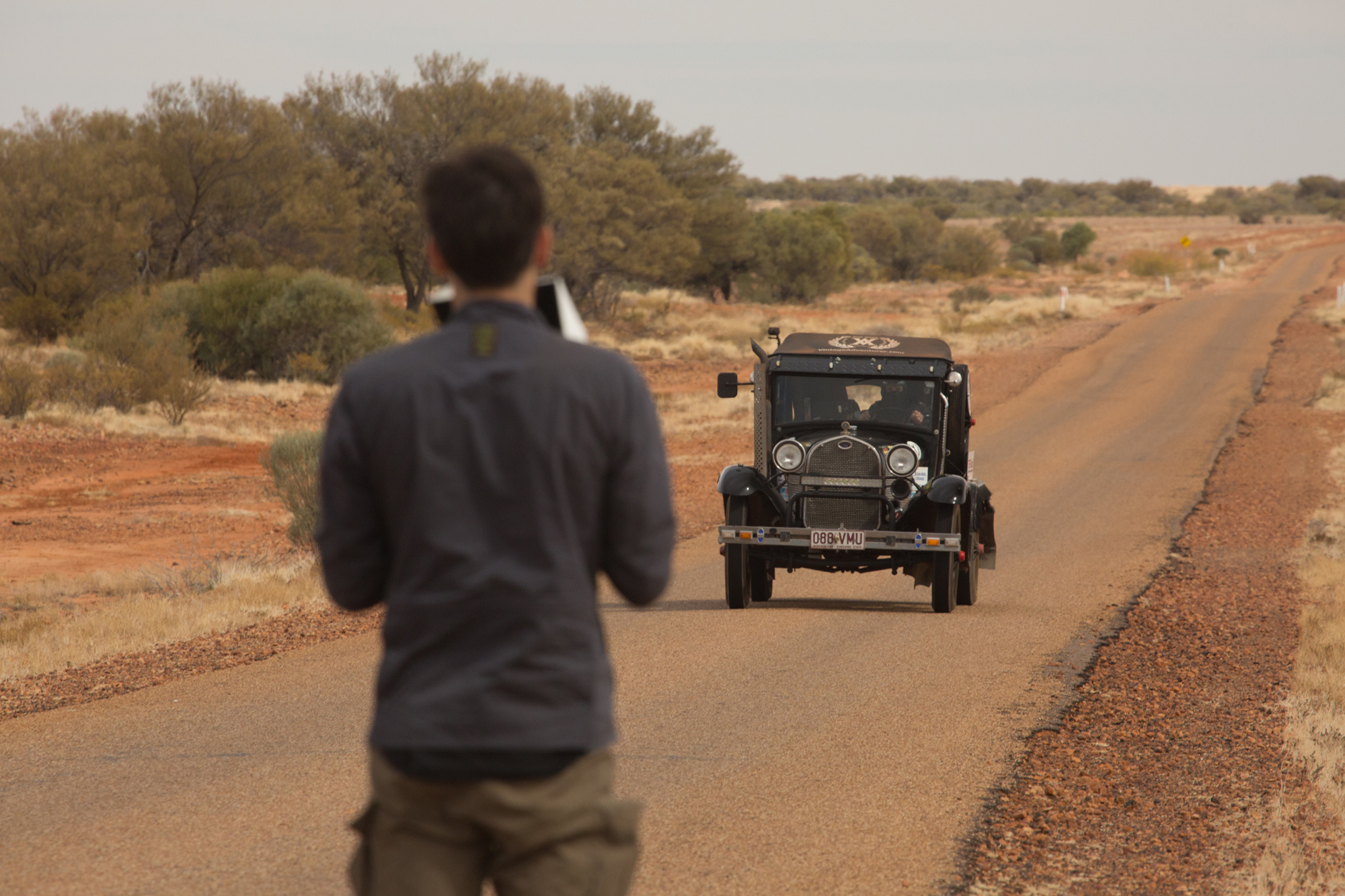 Ben Sherlock filming vehicle on road in Australia